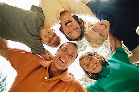 Portrait of Family Huddled Together Outdoors Stock Photo - Rights-Managed, Code: 700-00073096