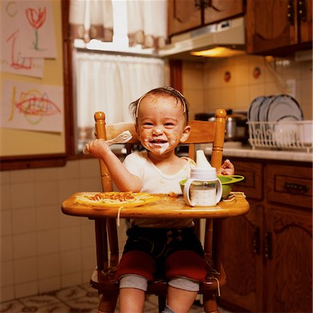 Portrait of Baby Sitting in High Chair with Food on Face Stock Photo - Rights-Managed, Code: 700-00073767