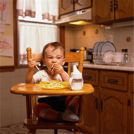 Baby Sitting in High Chair Eating Stock Photo - Rights-Managed, Code: 700-00073768