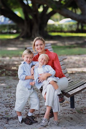 portrait of family on park bench - Portrait of Mother Sitting on Park Bench with Two Sons Stock Photo - Rights-Managed, Code: 700-00073942