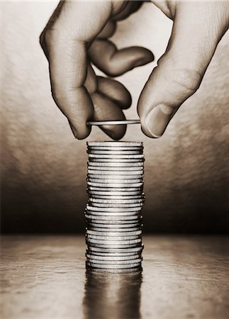 Close-Up of Hand Placing Coin on Stack Stock Photo - Rights-Managed, Code: 700-00084051