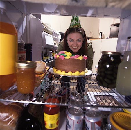 simsearch:700-00077881,k - Portrait of Woman Wearing Birthday Hat, Removing Birthday Cake from Fridge Stock Photo - Rights-Managed, Code: 700-00084098