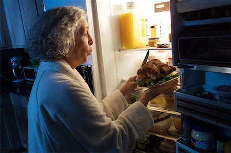 simsearch:695-05779160,k - Mature Woman Standing at Fridge Having Chicken as Midnight Snack Stock Photo - Rights-Managed, Code: 700-00084256