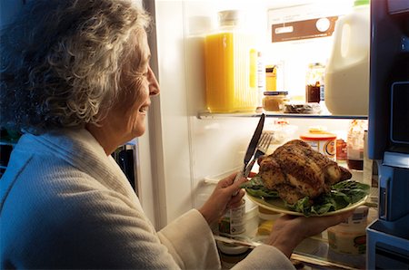 simsearch:695-05779160,k - Mature Woman Standing at Fridge Having Chicken as Midnight Snack Stock Photo - Rights-Managed, Code: 700-00084257