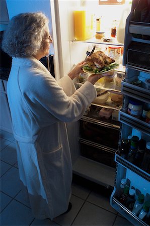 simsearch:695-05779160,k - Mature Woman Standing at Fridge Having Chicken as Midnight Snack Stock Photo - Rights-Managed, Code: 700-00084276
