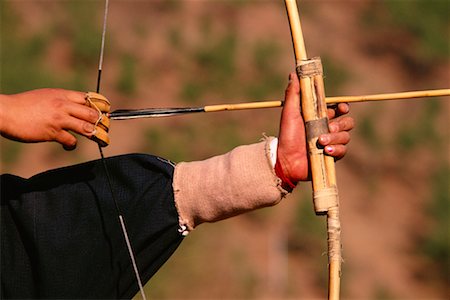 simsearch:858-06121555,k - Close-Up of Person Holding Bow And Arrow at Archery Contest Thimpu, Bhutan Foto de stock - Con derechos protegidos, Código: 700-00085135