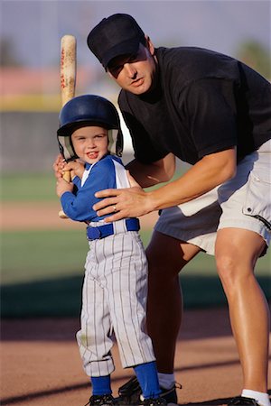 family in sports jerseys - Coach Helping Boy in Baseball Uniform at Batting Practice Stock Photo - Rights-Managed, Code: 700-00085409