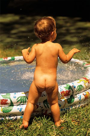Back View of Nude Child Standing By Inflatable Swimming Pool Stock Photo - Rights-Managed, Code: 700-00085422