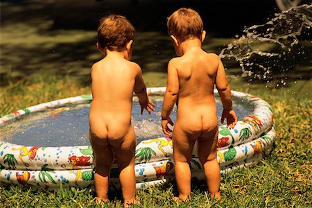 Back View of Two Nude Children Standing by Inflatable Swimming Pool Stock Photo - Rights-Managed, Code: 700-00085423