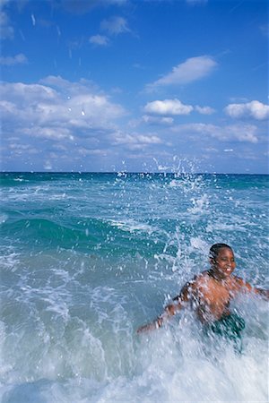 Boy Playing in Waves on Beach Stock Photo - Rights-Managed, Code: 700-00085439