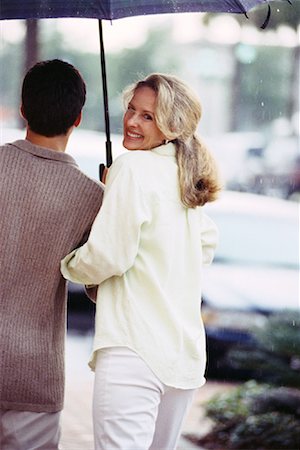 simsearch:700-00090323,k - Back View of Couple Walking on Street with Umbrella Stock Photo - Rights-Managed, Code: 700-00085518
