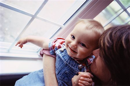 Mother Embracing Baby near Window Fotografie stock - Rights-Managed, Codice: 700-00085525