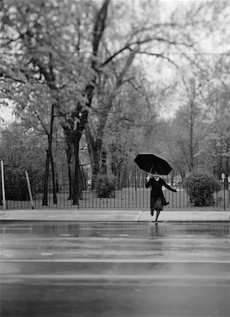 Woman Crossing Street with Umbrella in Rain Stock Photo - Rights-Managed, Code: 700-00085579