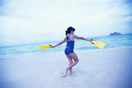 Girl in Swimwear, Walking on Beach Holding Flippers Stock Photo - Rights-Managed, Code: 700-00085616