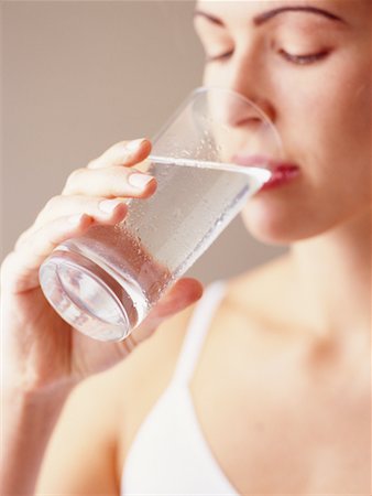 satisfied (thirst) - Woman Drinking Glass of Water Foto de stock - Con derechos protegidos, Código: 700-00086037