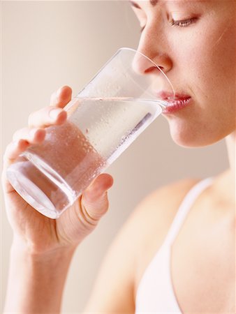 satisfied (thirst) - Woman Drinking Glass of Water Foto de stock - Con derechos protegidos, Código: 700-00086039