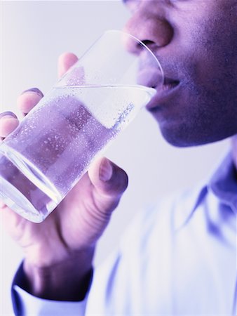 satisfied (thirst) - Close-Up of Man Drinking Glass of Water Foto de stock - Con derechos protegidos, Código: 700-00086067