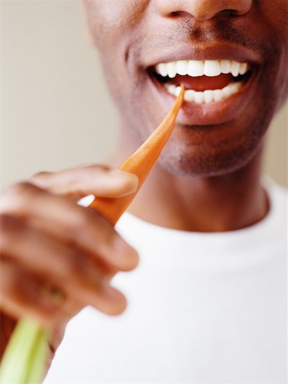 Close-Up of Man Eating Carrot Stock Photo - Premium Rights-Managed, Artist: Michael Alberstat, Image code: 700-00086060