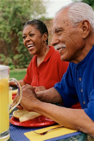 Mature Man and Woman Sitting at Table with Food Outdoors Stock Photo - Rights-Managed, Code: 700-00086214