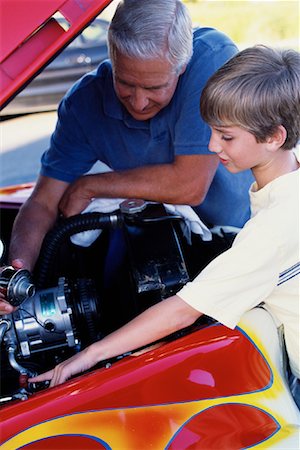Grandfather and Grandson Working On Engine in Hot-Rod Stock Photo - Rights-Managed, Code: 700-00086239