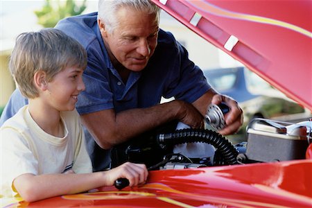 Grandfather and Grandson Working On Engine in Hot-Rod Stock Photo - Rights-Managed, Code: 700-00086240
