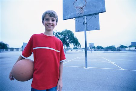 Portrait of Boy Holding Basketball on Outdoor Basketball Court Stock Photo - Rights-Managed, Code: 700-00086262