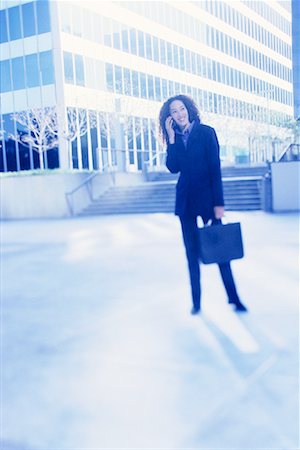 simsearch:700-00071171,k - Businesswoman Standing Outdoors Using Cell Phone Fotografie stock - Rights-Managed, Codice: 700-00086275