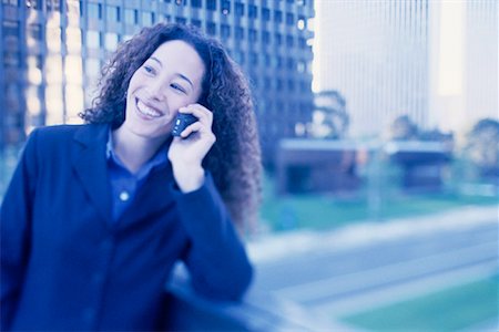 simsearch:700-00071171,k - Businesswoman Using Cell Phone Smiling Outdoors Stock Photo - Rights-Managed, Code: 700-00086286