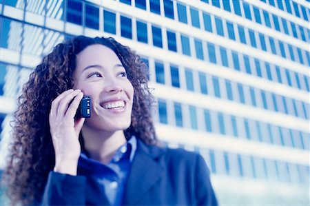 simsearch:700-00071171,k - Businesswoman Using Cell Phone Smiling Outdoors Stock Photo - Rights-Managed, Code: 700-00086289
