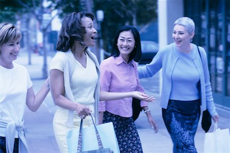 simsearch:700-00086329,k - Four Women Walking Outdoors Carrying Shopping Bags Stock Photo - Rights-Managed, Code: 700-00086319