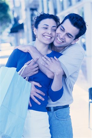 simsearch:700-00086310,k - Couple Embracing and Holding Shopping Bags Outdoors Stock Photo - Rights-Managed, Code: 700-00086311
