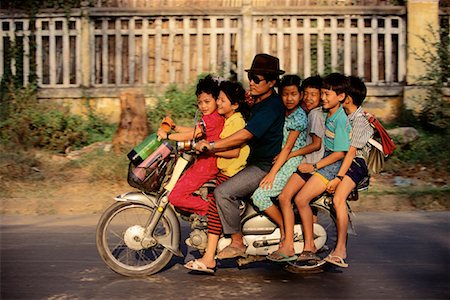 Man with Six Children on Motorcycle Phnom Penh, Cambodia Stock Photo - Rights-Managed, Code: 700-00086624