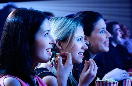 Three Girls Watching Movie in Theatre, Smiling Stock Photo - Rights-Managed, Code: 700-00086719