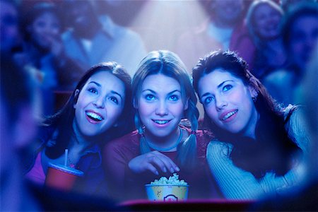 Three Girls Watching Movie in Theatre, Smiling Stock Photo - Rights-Managed, Code: 700-00086712