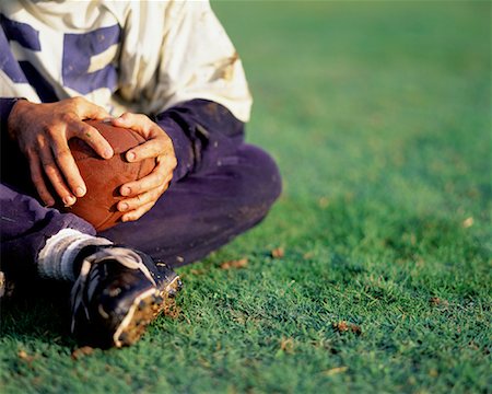 Man Sitting on Grass Holding Football Stock Photo - Rights-Managed, Code: 700-00087003