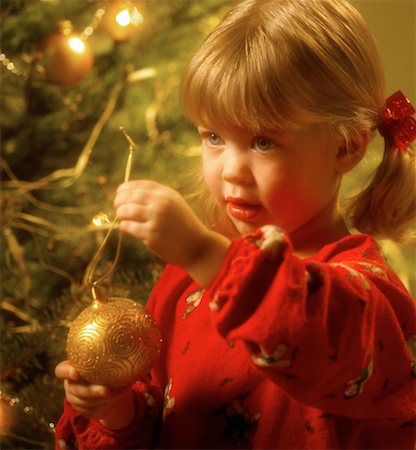 Girl Hanging Ornament on Christmas Tree Stock Photo - Rights-Managed, Code: 700-00087112