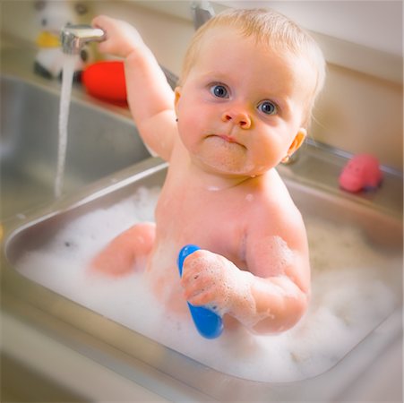 sink with bath bubbles - Baby Taking a Bath in Sink Stock Photo - Rights-Managed, Code: 700-00087280