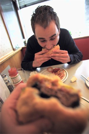 simsearch:700-01173684,k - Man Eating Hamburger Stock Photo - Rights-Managed, Code: 700-00088231