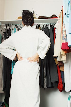 dresses closet - Femme regardant les vêtements dans le placard Photographie de stock - Rights-Managed, Code: 700-00088451