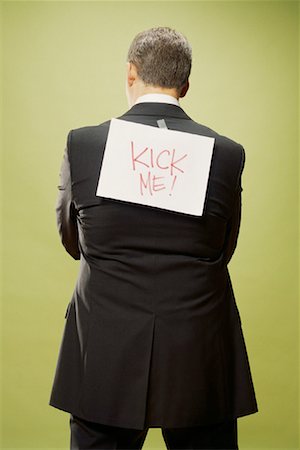 Homme avec le signe sur le dos Photographie de stock - Rights-Managed, Code: 700-00088609