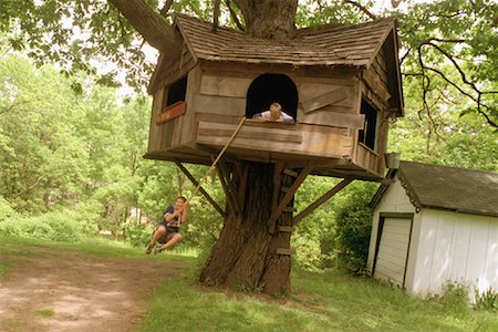 Boy Swinging on Rope by Tree House Stock Photo - Rights-Managed, Code: 700-00089518