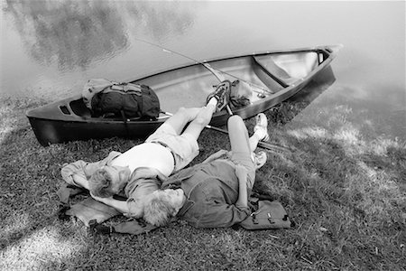 Back View of Mature Couple Relaxing on Shore with Canoe Stock Photo - Rights-Managed, Code: 700-00080556