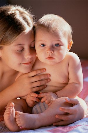 sister hugs baby - Portrait of Girl Embracing Baby Stock Photo - Rights-Managed, Code: 700-00080955