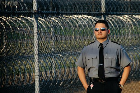 prison guards in uniform - Portrait of Male Prison Guard Outdoors, Michigan State Penitentiary, Michigan, USA Foto de stock - Con derechos protegidos, Código: 700-00081110