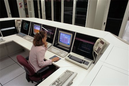 Woman Monitoring Computer Network At Stock Trading Company Stock Photo - Rights-Managed, Code: 700-00081159