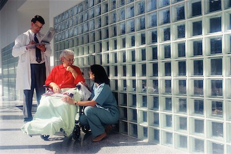 people with special needs working - Doctor and Nurse with Mature Female Patient in Wheelchair in Hospital, Saskatchewan, Canada Stock Photo - Rights-Managed, Code: 700-00081283