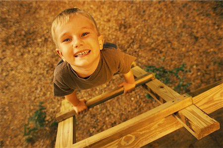Portrait of Boy Climbing Tree House Ladder Stock Photo - Rights-Managed, Code: 700-00081383