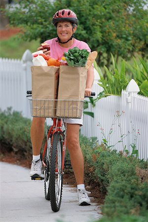 riding bike with basket - Portrait of Mature Woman on Bike With Bags of Groceries Stock Photo - Rights-Managed, Code: 700-00081398