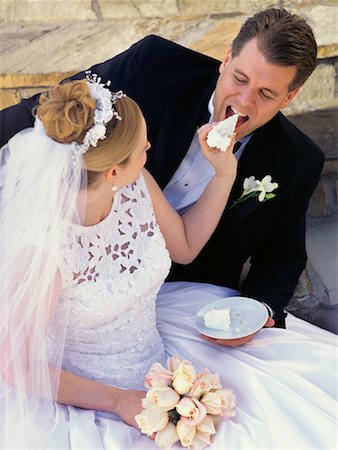 Bride Feeding Groom Slice of Wedding Cake Stock Photo - Rights-Managed, Code: 700-00081453