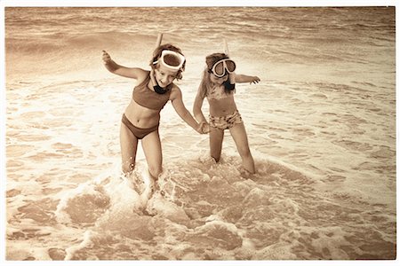 Two Girls in Swimwear, Wearing Snorkel and Goggles, Holding Hands on Beach Stock Photo - Rights-Managed, Code: 700-00081657